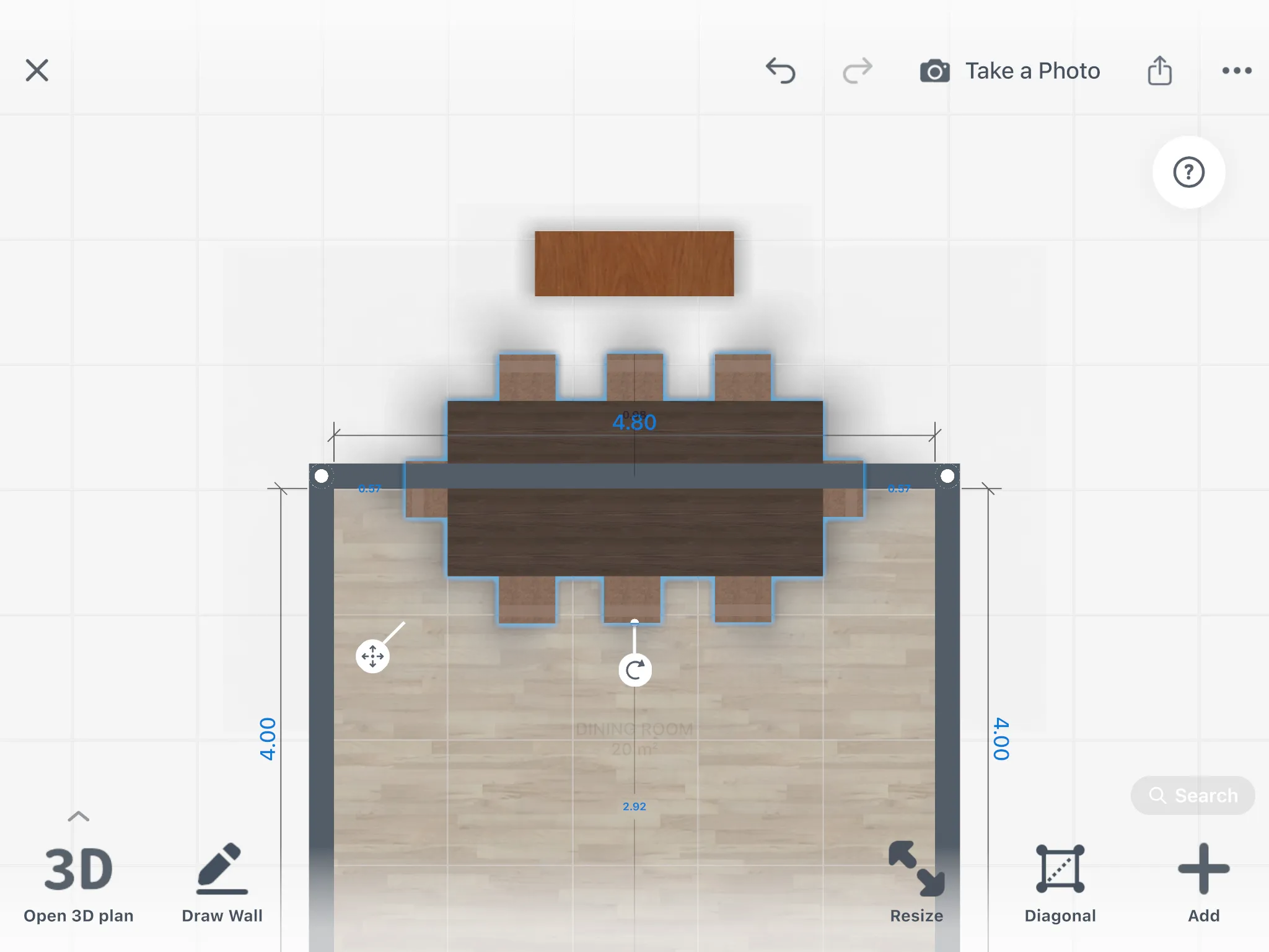 A dining table selected on the 2D plan, with its distance to the wall and the sideboard