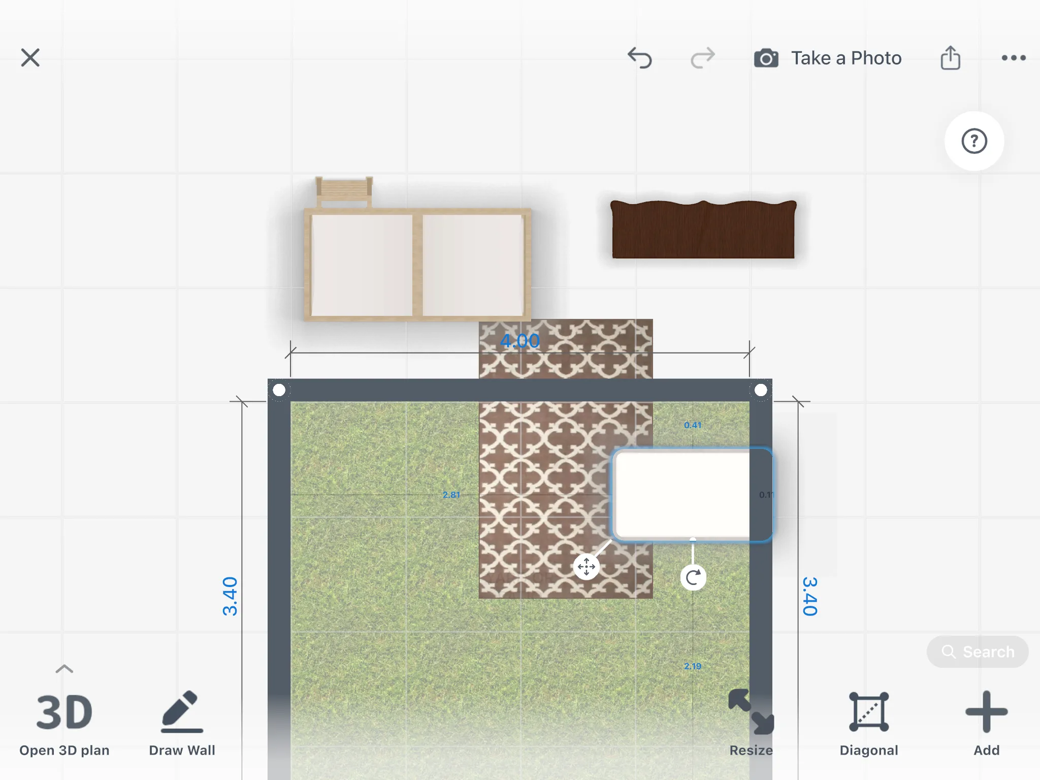 A crib selected on the 2D plan of a nursery, with its distance to the wall and the dresser