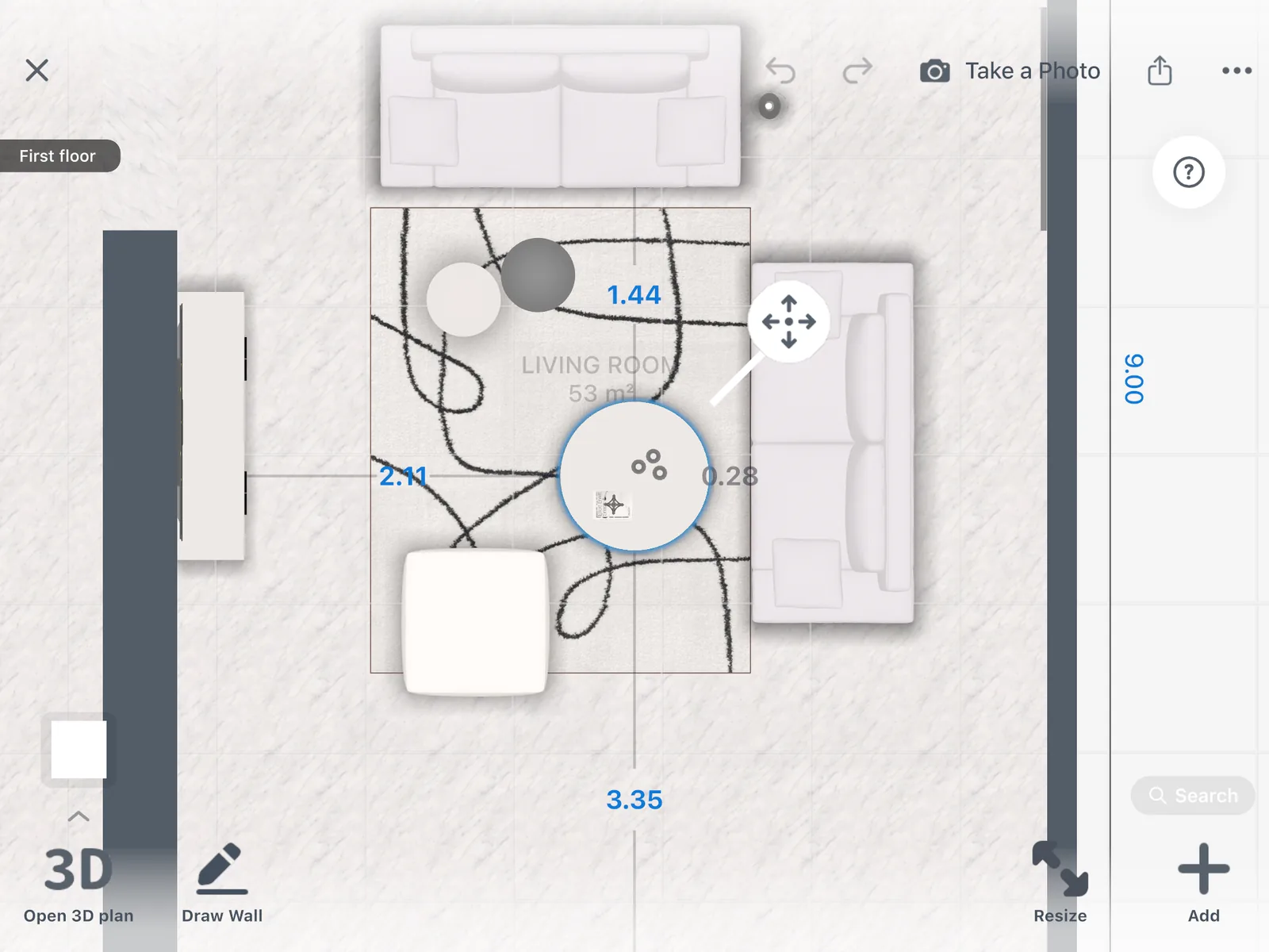 A round coffee table selected on the 2D plan of a living room, with its distance markers: 1.44 m and 0.28 m to the two sofas, 2.11 m to the sideboard, 3.35 m to the wall on the open side